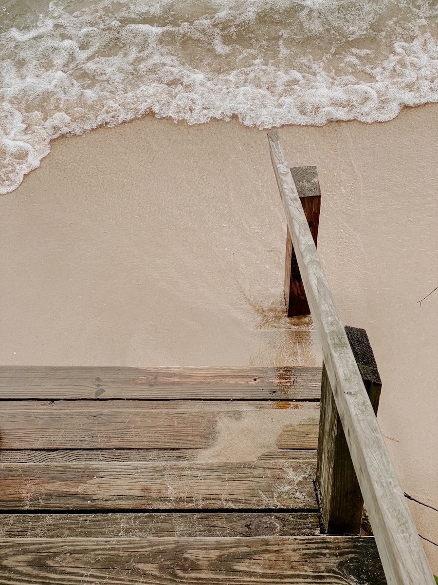 a close up of a wooden railing near the ocean